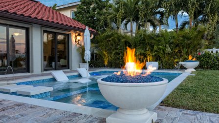 Pool with submerged seating and two fire cauldrons
