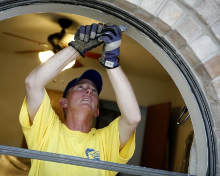 man replacing window
