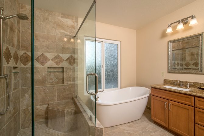Master Bathroom With Frameless Shower Stone Tile And Vanity