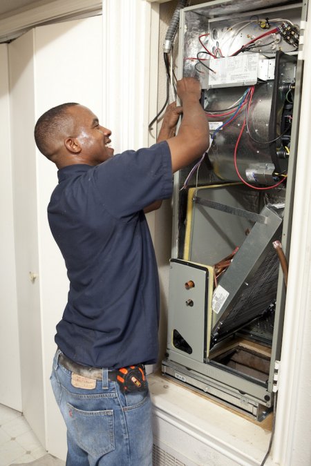 HVAC professional making electrical connections on Trane air handler