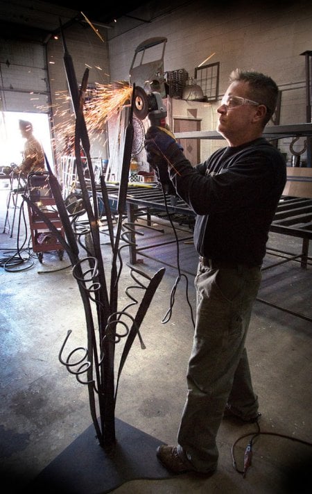 Ryan Feeney of Indy Art Forge completing a standing wine rack