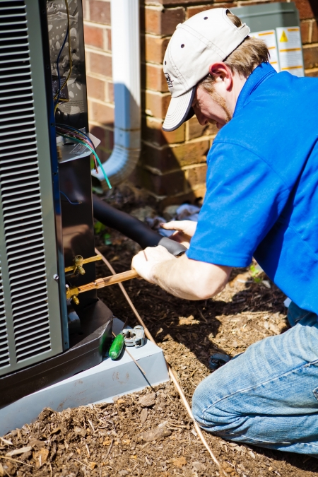 HVAC contractor installing an heating and air conditioning unit