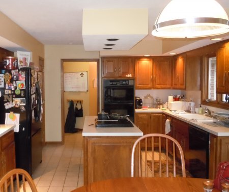 outdated kitchen with honey cabinets
