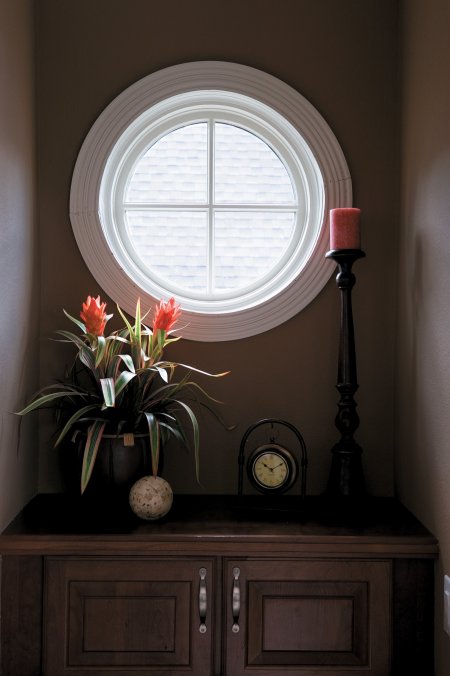 white circle window over dresser