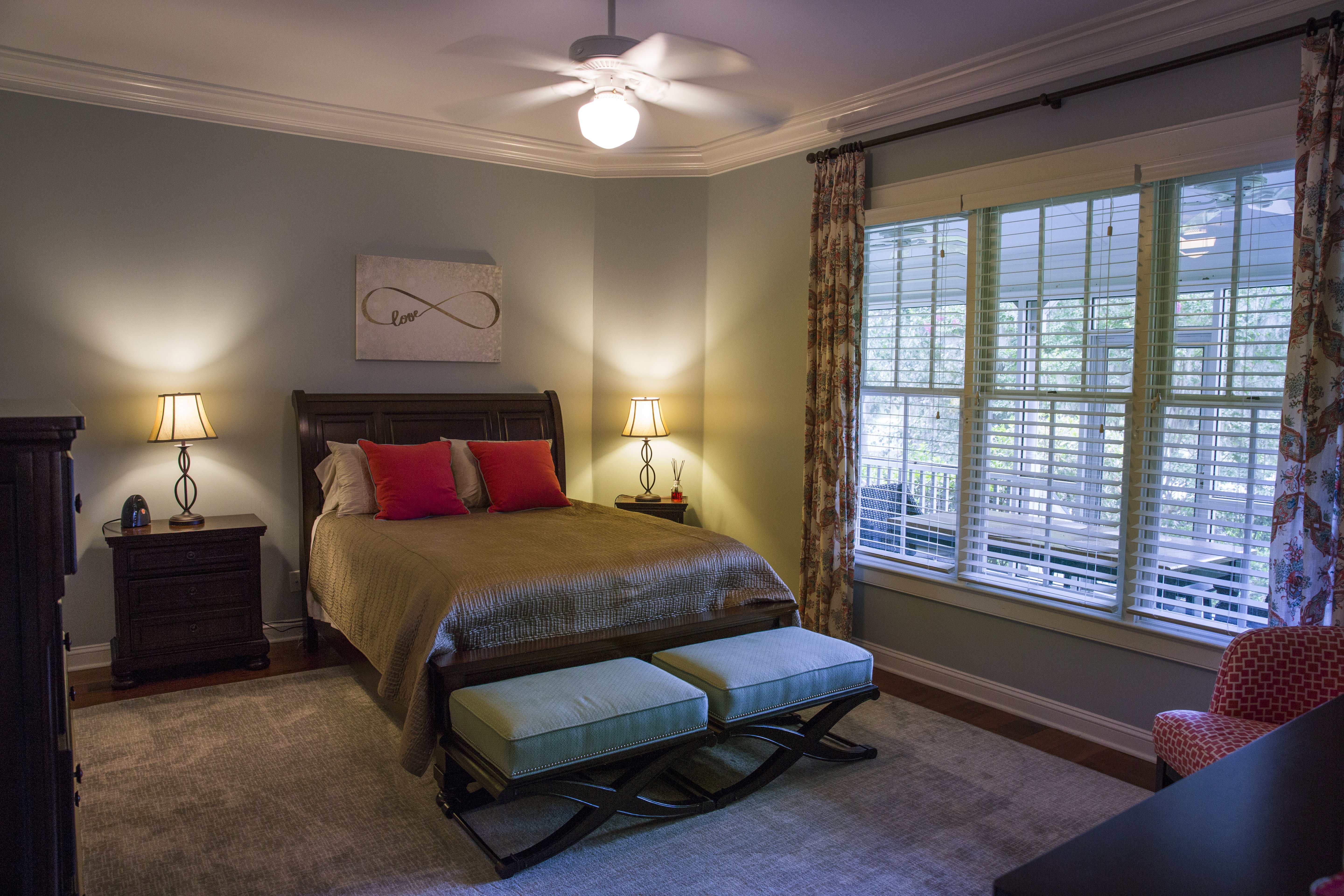 Southern style master bedroom with ceiling fan and lamps