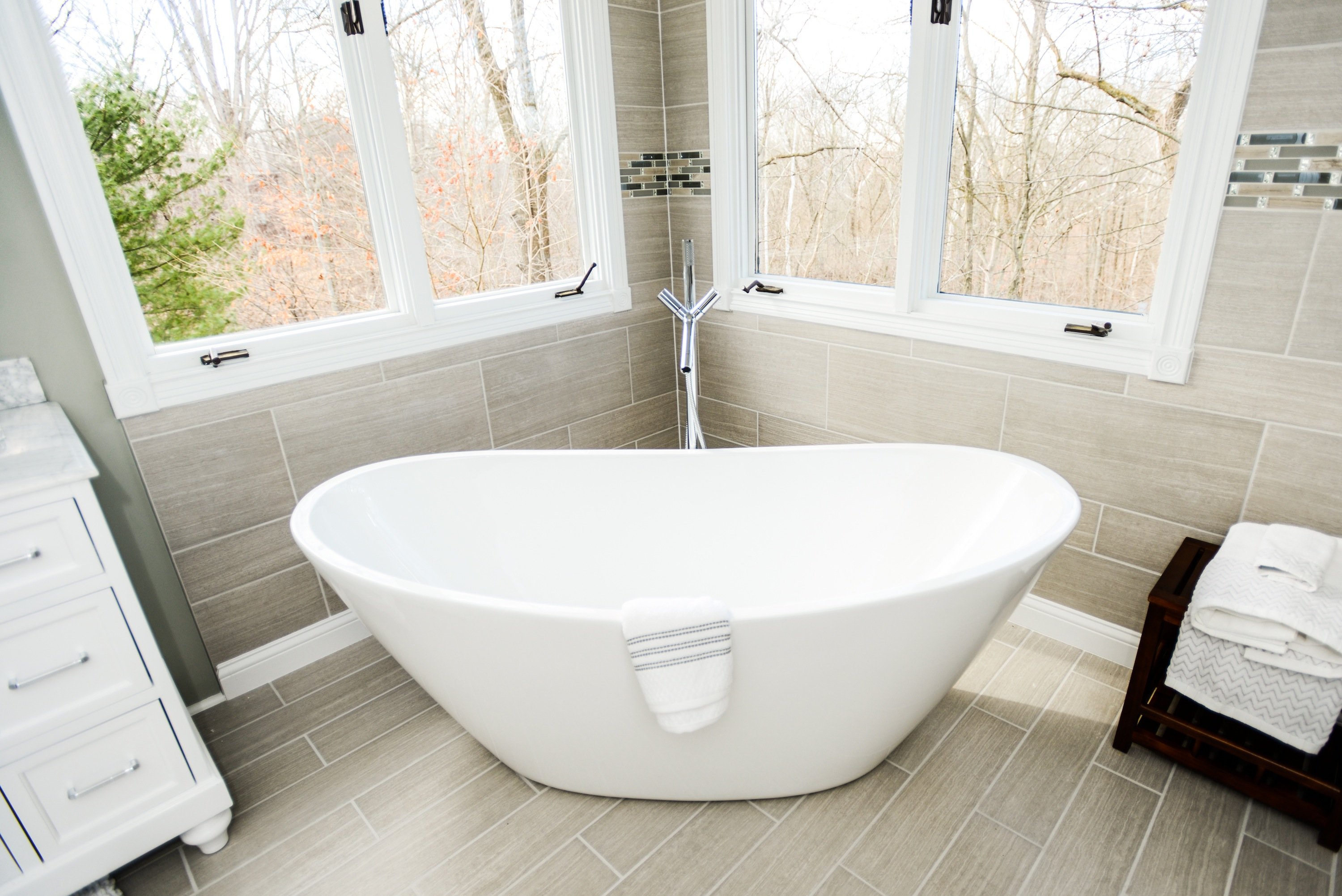 Large soaking bathtub shaped like basin inside bathroom