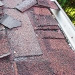 two layers of crumbling asphalt shingles 