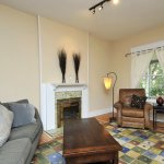 Living Room Lighting Ideas A living room with a fireplace and a hanging light fixture from a floor lamp