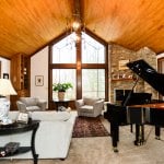 Living Room Lighting Ideas A large family room with a stone fireplace and baby grand piano