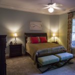 Southern style master bedroom with ceiling fan and lamps