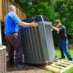 two men installing an HVAC unit 