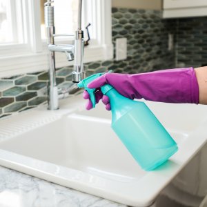 How To Clean Mold Mistakes Avoid Angie S List Cleaner Wearing Rubber Glove With Spray Bottle At Sink