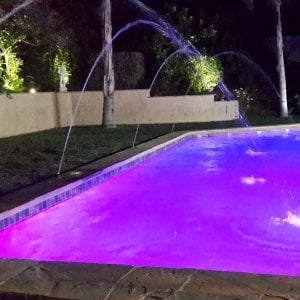 How Much Does It Cost To Resurface A Swimming Pool Angie S List Swimming Pool With Lavendar Colored Water And Sprinkler