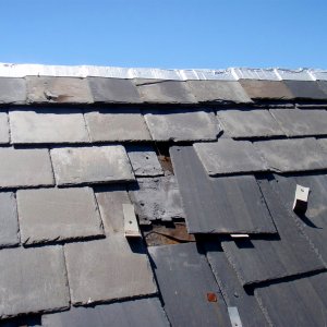 broken slate tiles slipping from roof