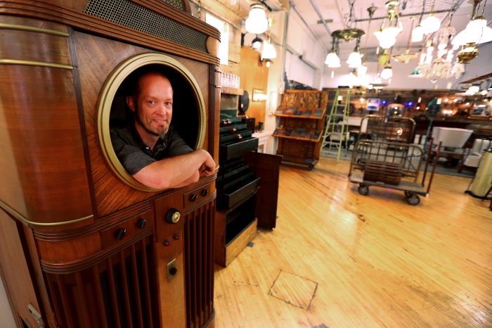 Bret Hodgert stands inside a Mills Panoram Soundie, manufactured in November 1940 (Photo by Brent Drinkut)