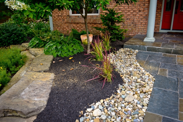 How To Reuse Stone Angie S List Orted Rocks Serve As Edging And A Border Between Flagstone Walkway Flower Bed Opposite The Stone Slab Garden Wall Provides Easy Walking