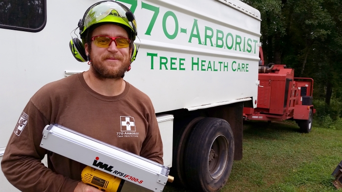 Mark Russell standing in front of his company truck