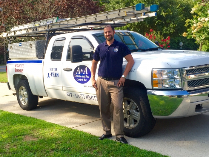 man standing in front of his company truck