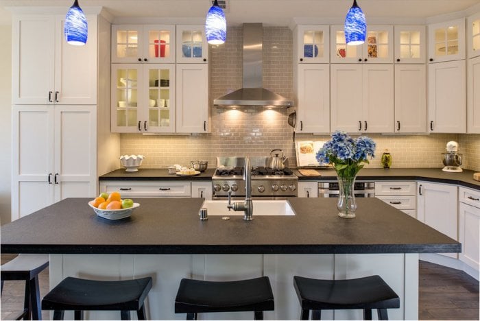 Adding some colored overhead lights and under-cabinet lighting in your kitchens brightens the room and adds color. (Photo courtesy of Joe Christenson/Remodel Works)
