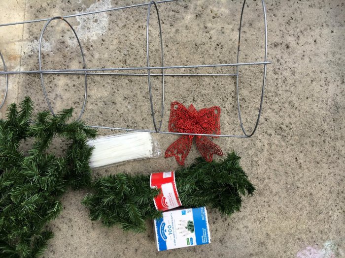 All you need is a large tomato cage, zip ties, garland and décor. (Photo by Melissa Riker/The Happier Homemaker)