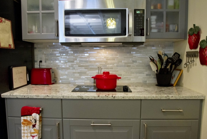kitchen with backsplash, stovetop and microwave