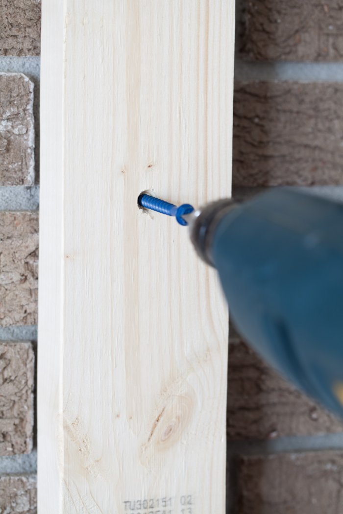 drill screwing nail into board