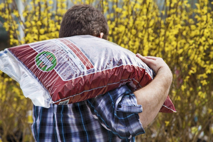 man carrying mulch bag
