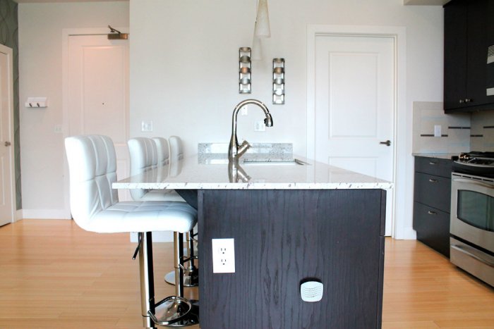 Kitchen Island Seating With Stools Or Chairs Angie S List Two Armless White Leather Bar Stools At Ebony Colored Kitchen Island With A Marble Countertop