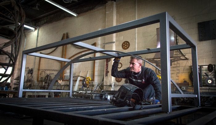 Ryan Feeney of Indy Art Forge checks out a metal table in progress