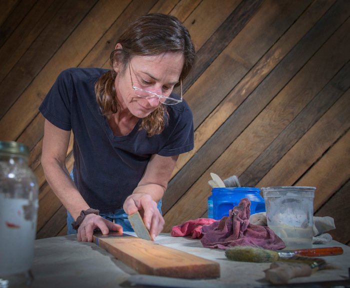 Wild Zen, Inc. owner Liza Oates creating faux finish on wood