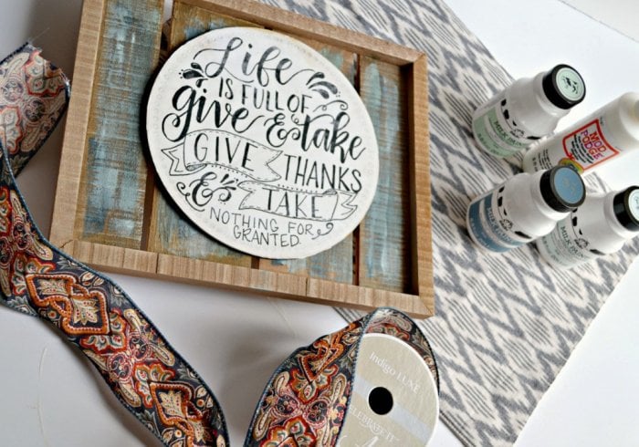 Grab a wood pallet sign, a small round plaque, some paint, photo transfer mod podge and ribbon to make this beautiful sign for your home.