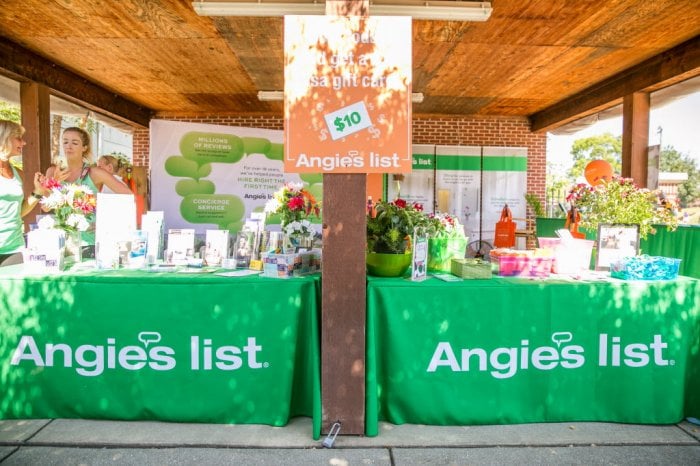 Two green Angie's List tables with pamplets at the Indiana State fair