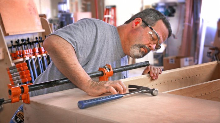 Wood worker C.R. Gallagher putting together a cabinet for Madison County Cabinets in Pendleton, Indiana.