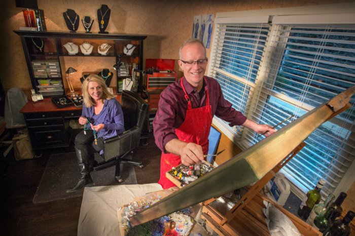 Randy Sorrell painting and Kimberly Sorrell making jewelry in their dining space