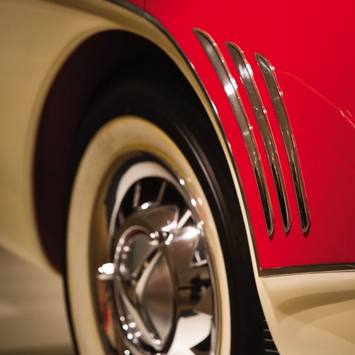 closeup of the tire on a rare red and cream concept car with white wall tires on chrome