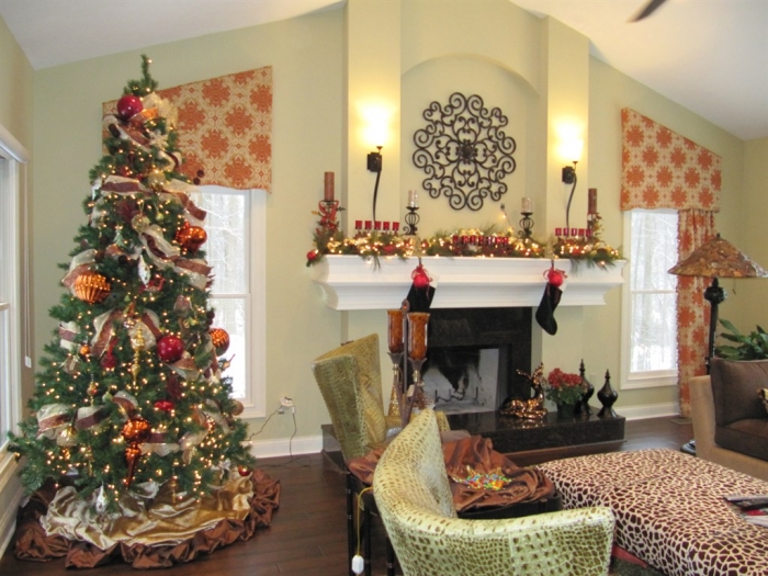 holiday-decorated living room with tree and mantel