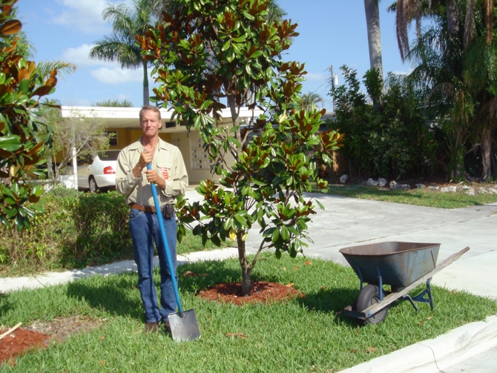 John Rochester standing in yard with shovel