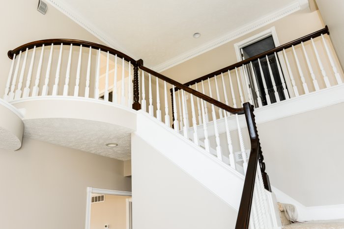 balcony black rail white stairs entry in foyer (Photo by Summer Galyan)