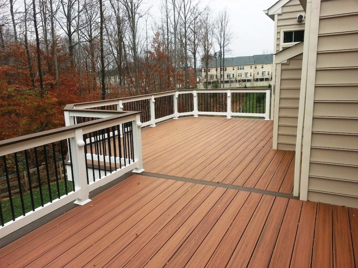 deck with white railing and metal spindles