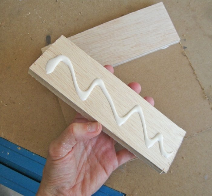 hand holding wood with glue
