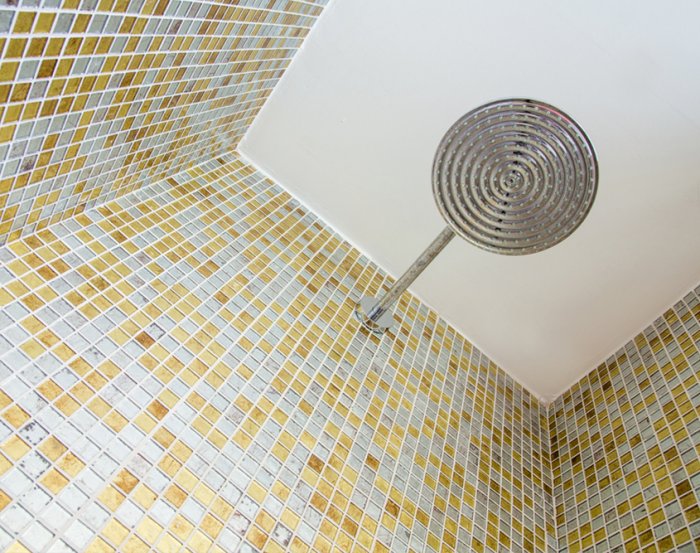 View upward from floor of shower to shower head