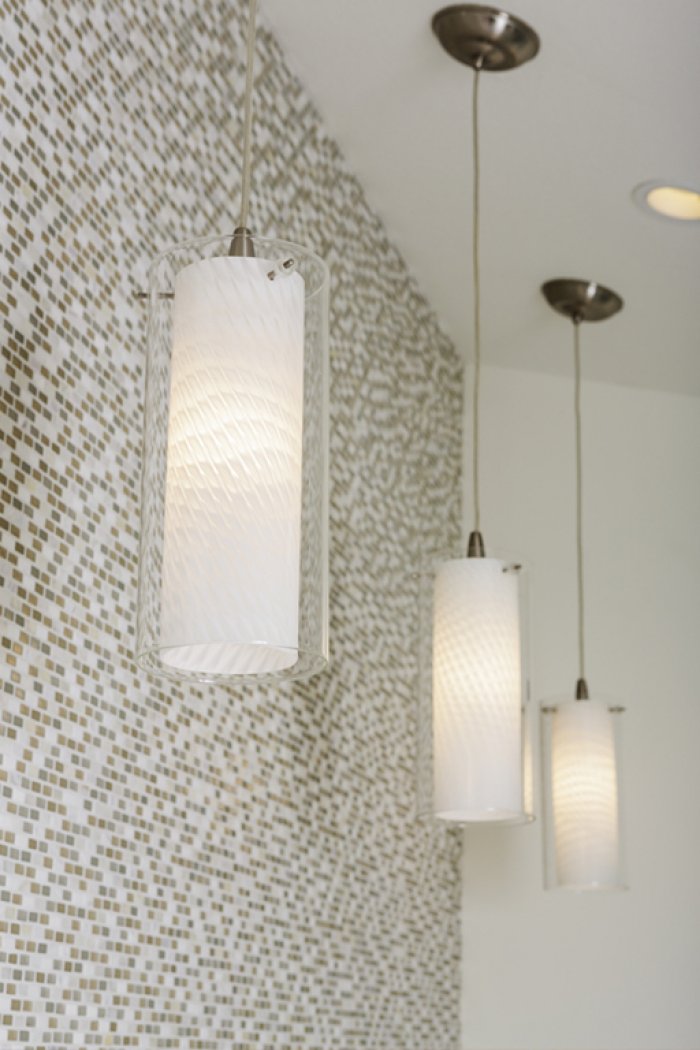 Pendant lights against tiled backdrop