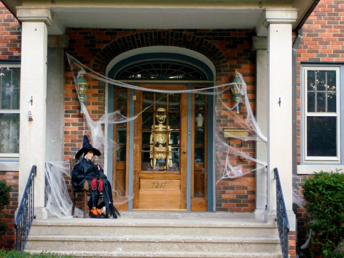 Halloween porch with cobwebs, skeleton and witch
