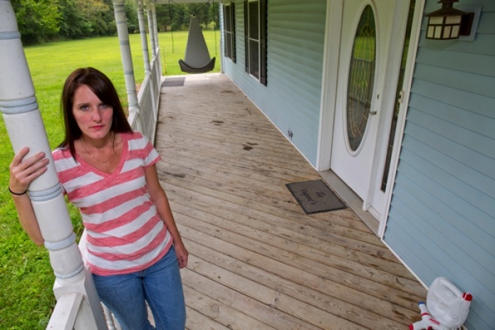homeowner stands outside meth contaminated house