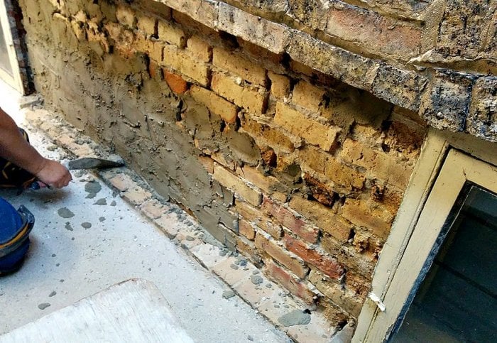 old brick wall being repointed