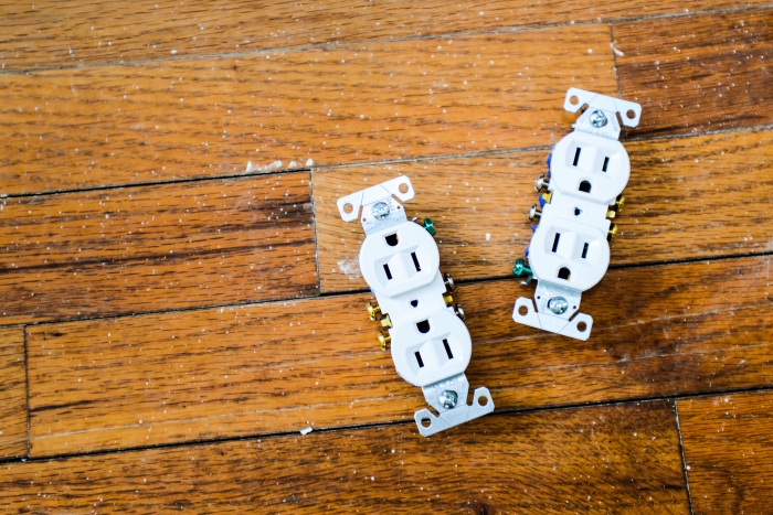 two unhooked outlets on a wood floor