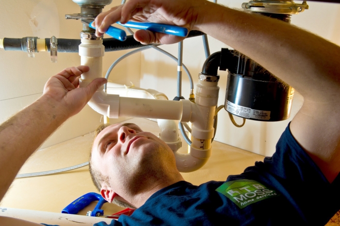 plumber working on pipes