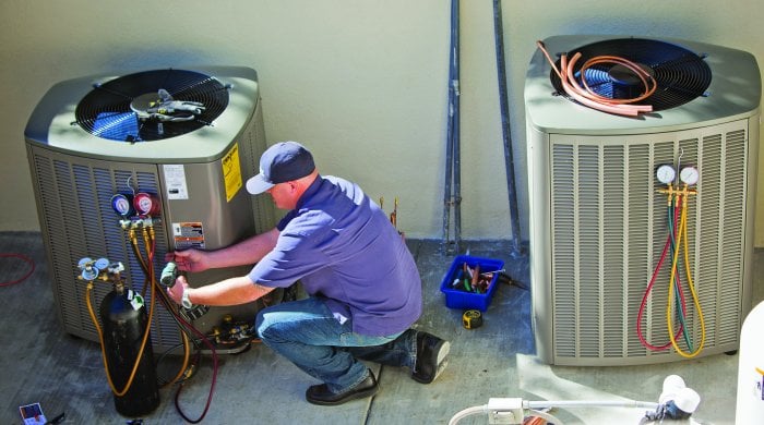 HVAC technician checking refrigerant