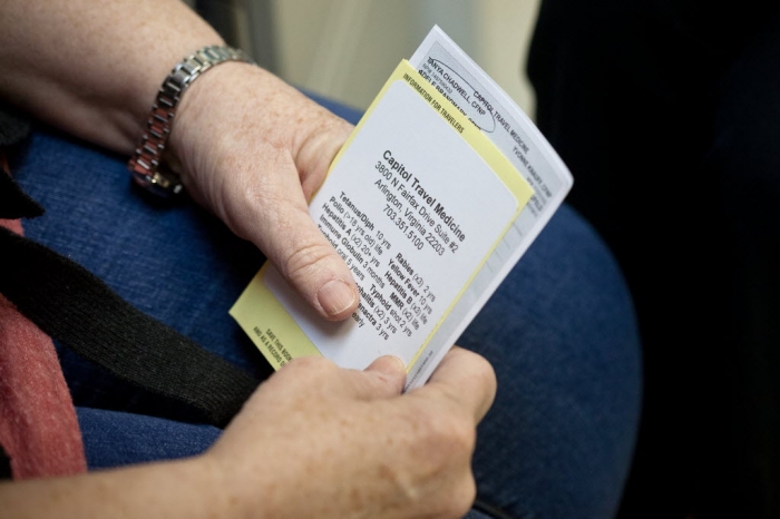 man holds medical receipt