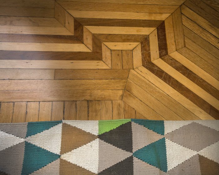 A bold geometric rug pattern and unique flooring adds visual interest. (Photo by Frank Espich)